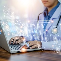 Doctor at desk using AI on his computer