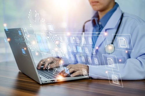 Doctor at desk using AI on his computer
