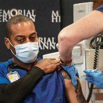 Healthcare worker receives vaccine shot