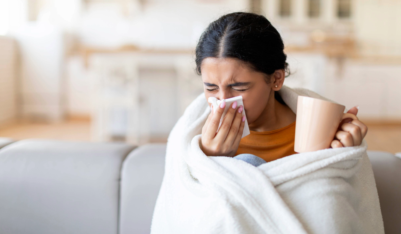 Woman sneezing and sick