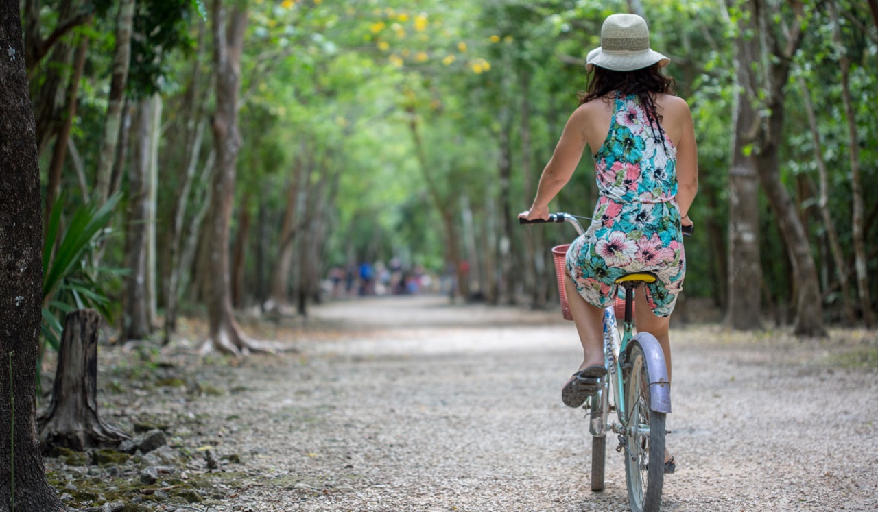 A woman riding a bicycle along a path.