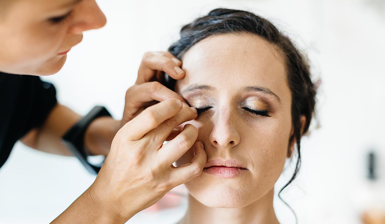 A woman having eyelashes applied