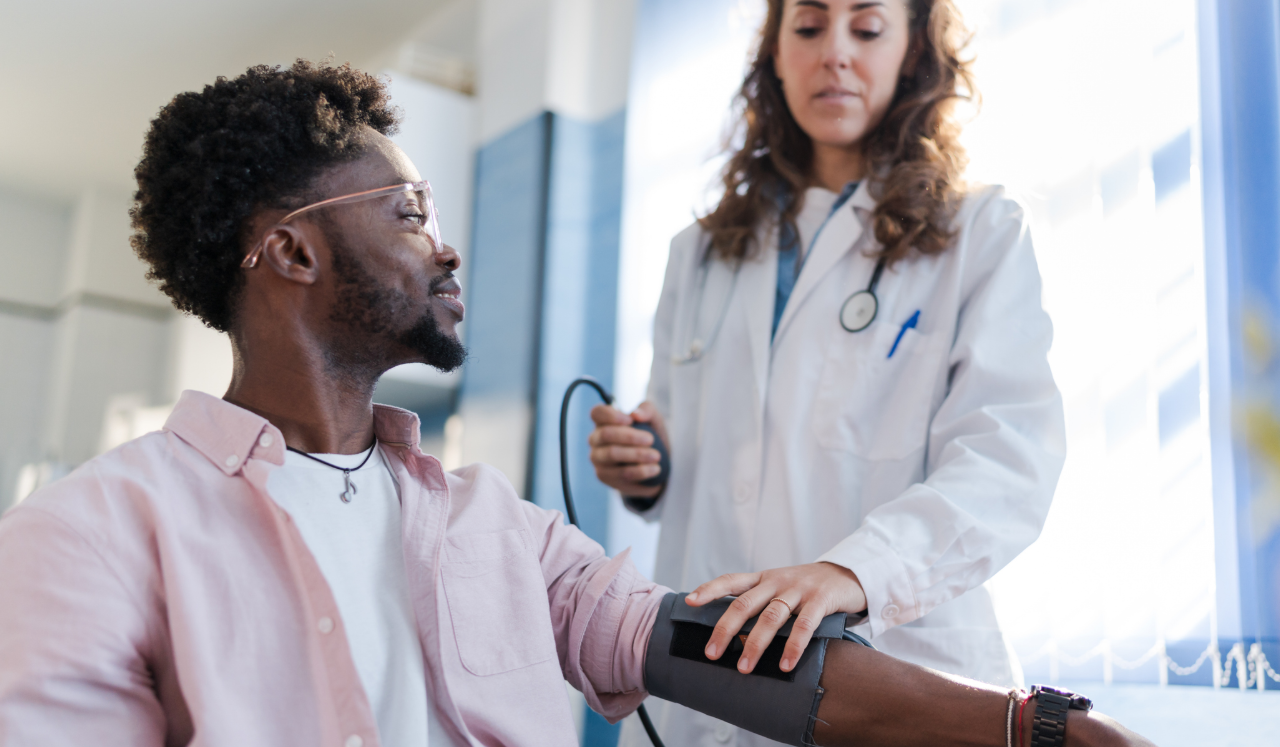 Doctor checking patients blood pressure