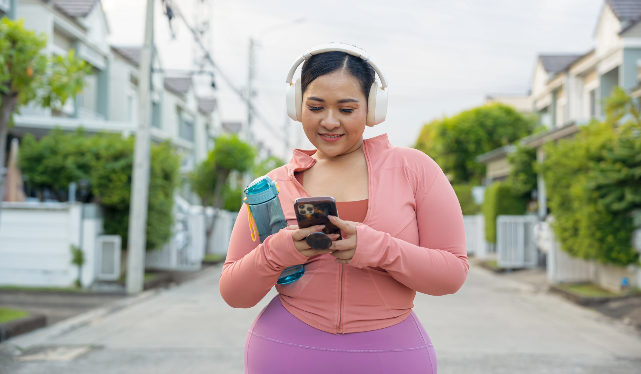 Woman checking phone while working out.