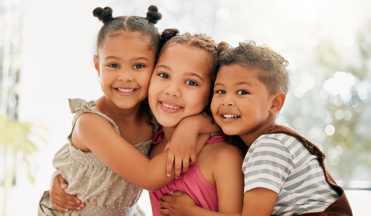 Siblings hugging eachother.