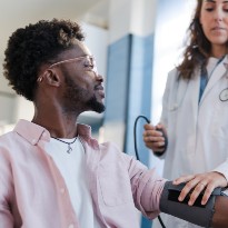 Doctor checking patients blood pressure