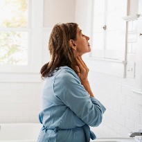 Woman checking her thyroid glands