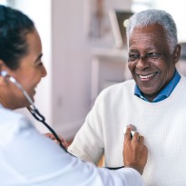Doctor checking patients heart.