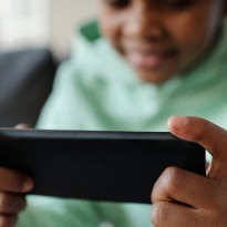 Child staring at tablet.