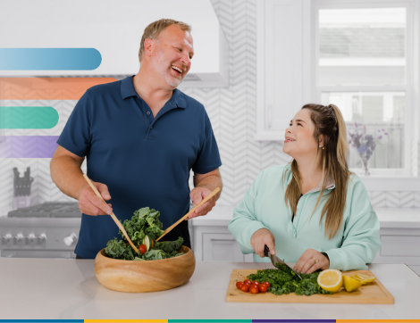 man and woman in kitchen laughing