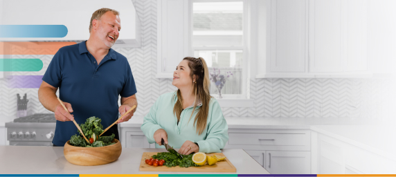 man and woman in kitchen laughing