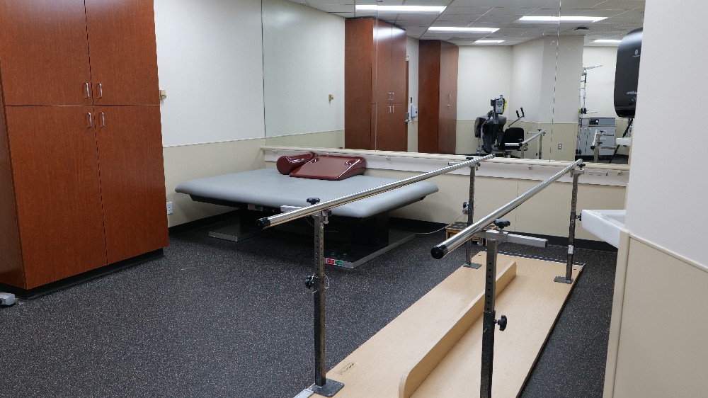 Rehabilitation room with assistive devices at TIRR Memorial Hermann Southwest Hospital Inpatient Rehabilitation