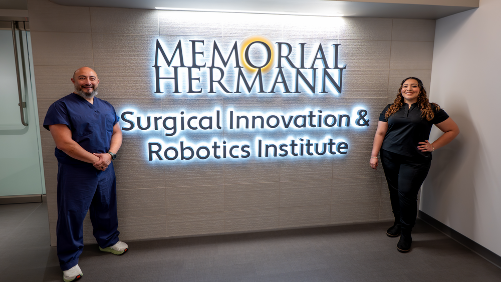 Memorial Hermann Surgical Innovation & Robotics Institute entrance signage and team members