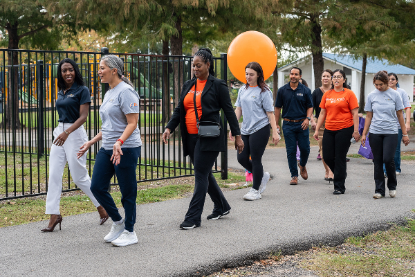 group of individuals walking in the park