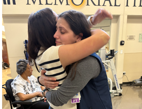 Former patient of TIRR Memorial Hermann, Dawson Oliver, gives hugs as she leaves inpatient therapy.