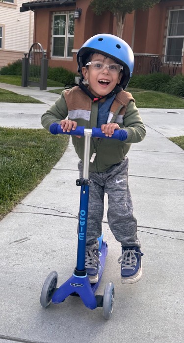 patient zayn riding scooter smiling