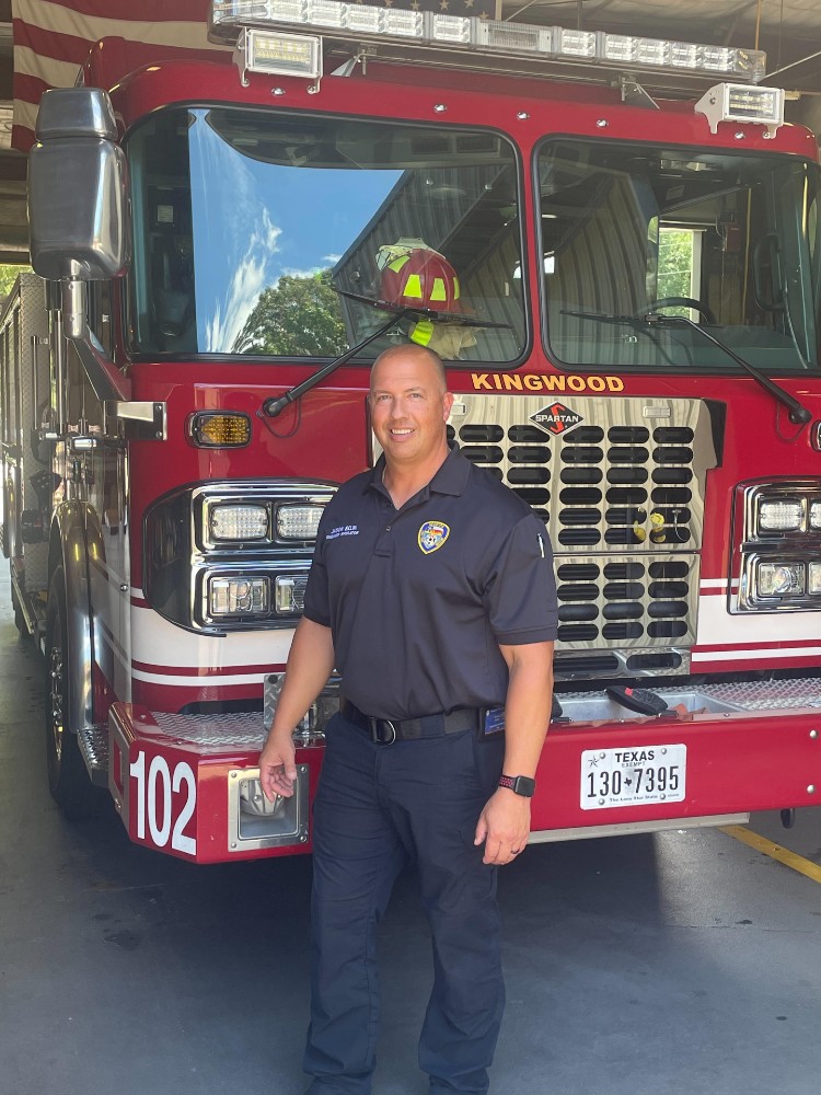 Patient Jason Belin in front of firetruck