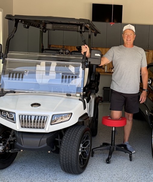 patient posing with golf cart