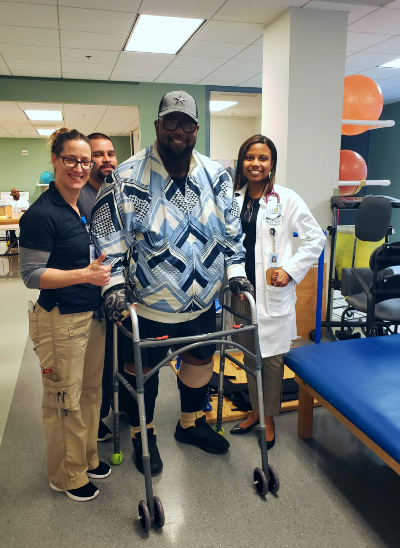 Anthony stands with his rehabilitation team at Memorial Hermann Rehabilitation Hospital - Katy