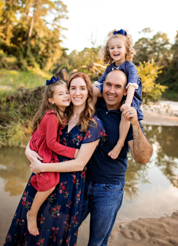 A portrait of Carrie Jobe, a TIRR Memorial Hermann patient, with her daughters and husband.