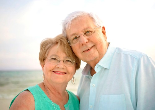 TIRR Memorial Hermann patient, Gary Thompson, stands on the beach with his wife.