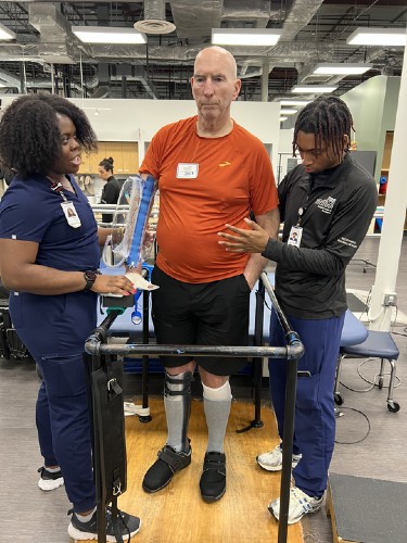 TIRR Memorial Hermann patient, John Eidman, works with physical therapists at TIRR facilities.