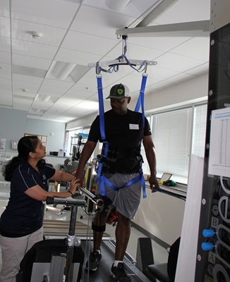 Edgar Venson using assistive equipment to walk at Rehabilitation Hospital - Katy