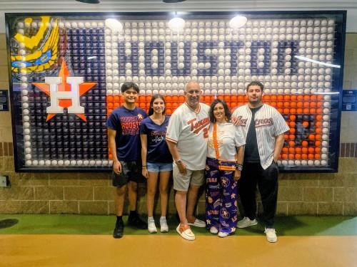 TIRR Memorial Hermann former patient, Armando Rodriguez, with his family at an Astros game.