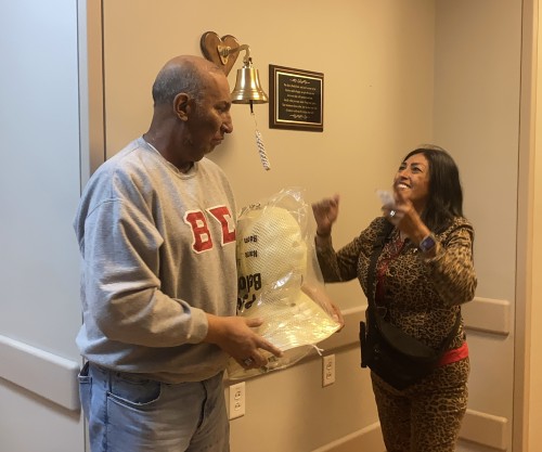 TIRR Memorial Hermann former patient, Armando Rodriguez, rings bell.