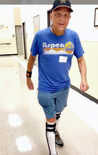 TIRR Memorial Hermann patient, Ed Watkins, walks the hallways after lymphedema management.