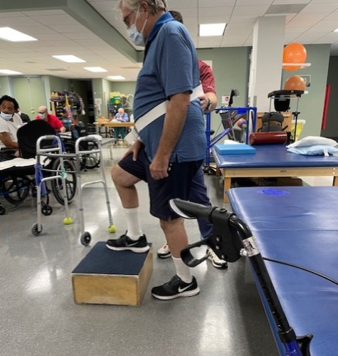 TIRR Memorial Hermann patient, Steve Howell, works with therapists in the gym.