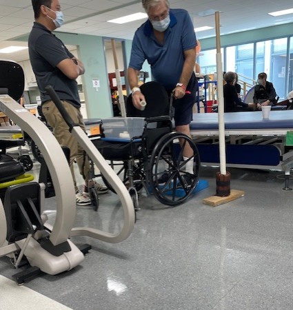 TIRR Memorial Hermann patient, Steve Howell, works with therapists in the gym.
