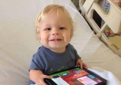 TIRR Memorial Hermann pediatric patient, Zach, plays on his ipad at the hospital.