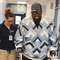 Anthony Antwine using a walker as he regains mobility