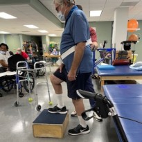 TIRR Memorial Hermann patient, Steve Howell, works with therapists in the gym.
