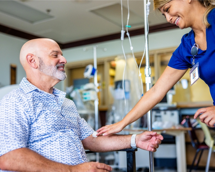 A medical professional provides infusion therapy to male patient. 