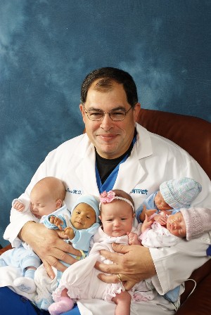 Dr. Richard Rivas holding babies