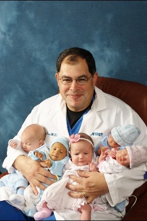 Dr. Richard Rivas holding babies