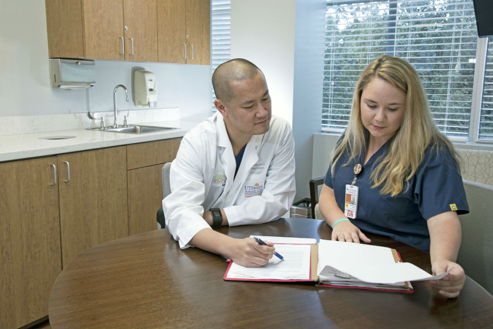 Doctor and nurse reviewing files