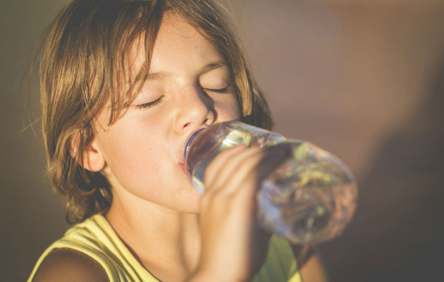 Child drinking water from  a bottle