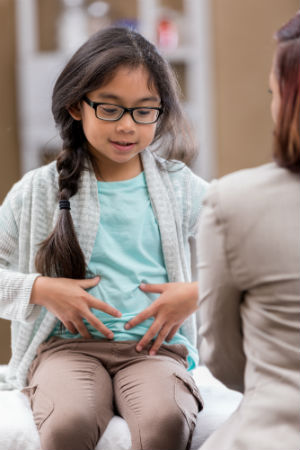 Child pointing at stomach