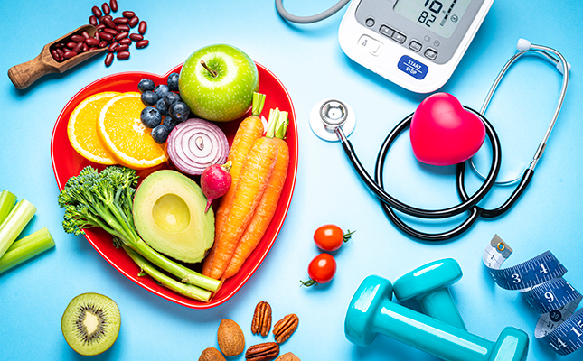 array of fruits, veggies, doctor's equipment and hand weights