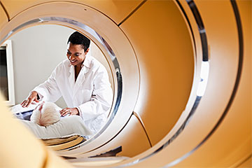 patient and attendant preparing for PET CT Scan