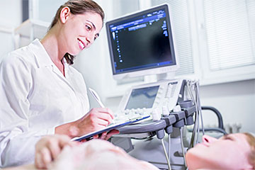 Technologist with Patient During an Ultrasound