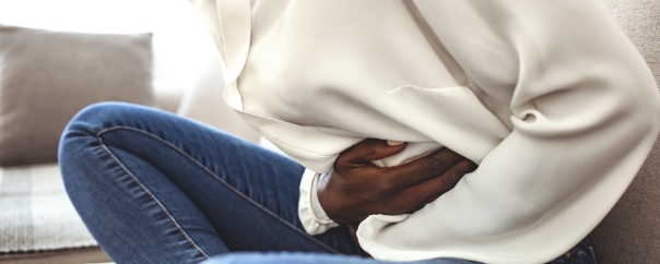 person clutching stomach in pain