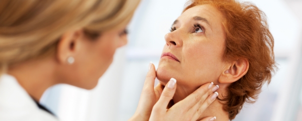 doctor checking thyroid