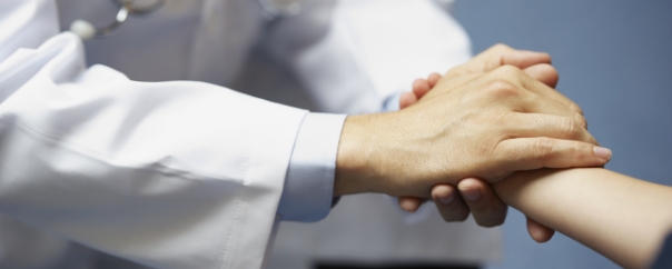 doctor holding patient's hand