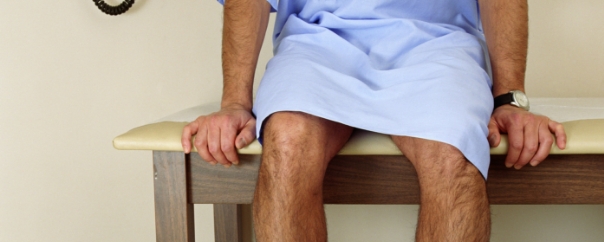 man sitting on exam table