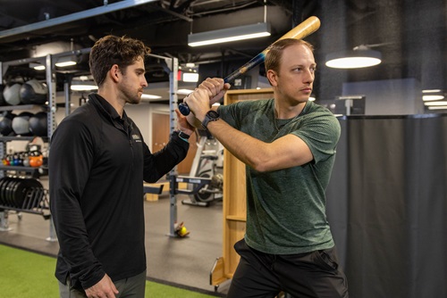Trainer helping patient