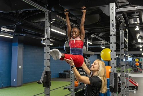 Gymnast training with physical therapist